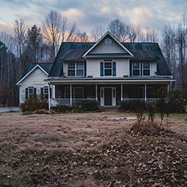 two-story house with dark roof in winter