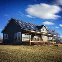 house with porch with solar panels on roof