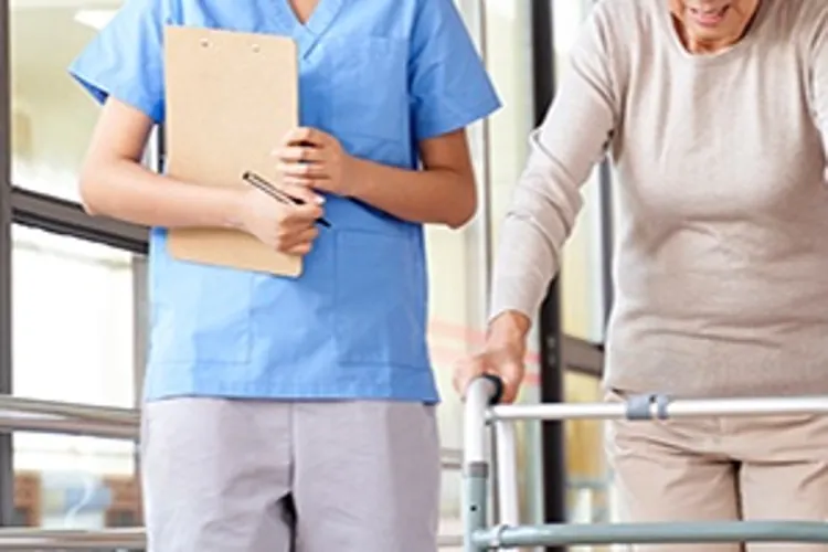 nurse walking with an older woman with a walker