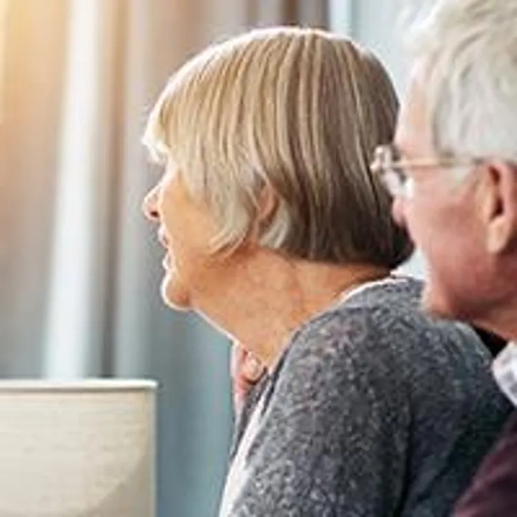 nurse with elderly couple smiling