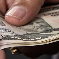 man handing money to another man