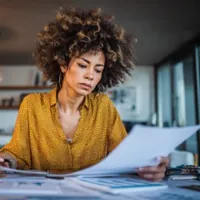 a woman reading through paperwork