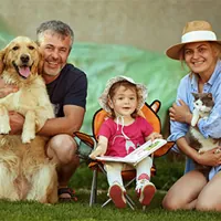 couple with young daughter and dog and cat