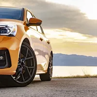 car by the road with the sun setting