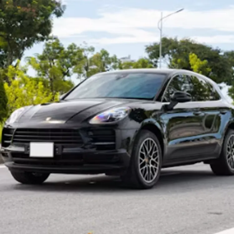A black luxury SUV drives on a city street, highlighting auto warranty and insurance topics.