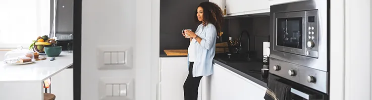 pregnant woman standing in kitchen