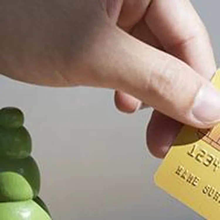 a hand holding a credit card