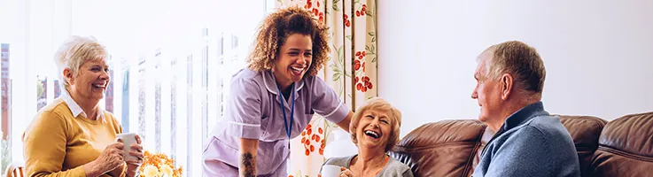 group of older people sitting around a living room