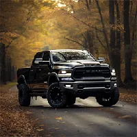 ram truck on a road surrounded by trees during autumn
