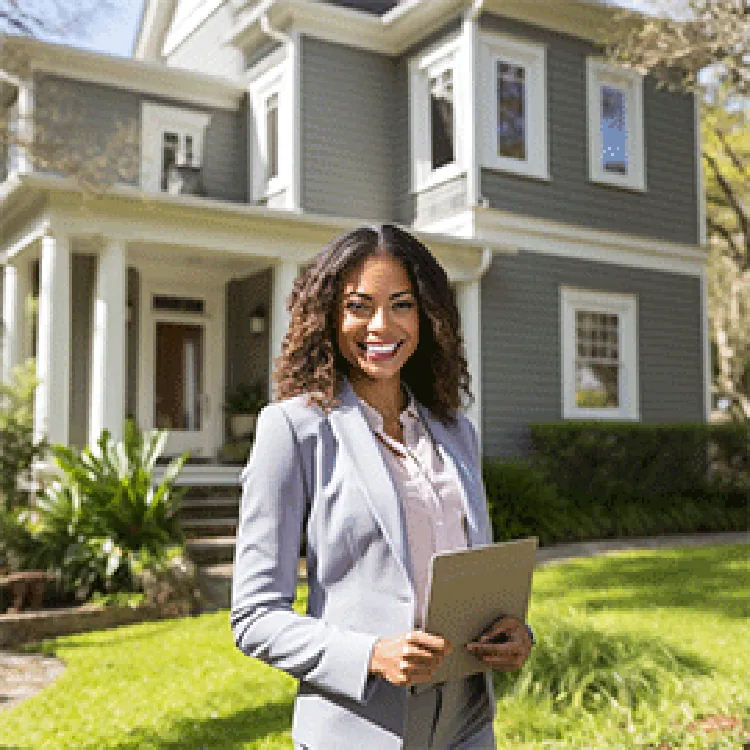agent standing in front of a beautiful house