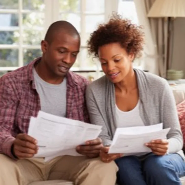 a man and a woman looking at paperwork together