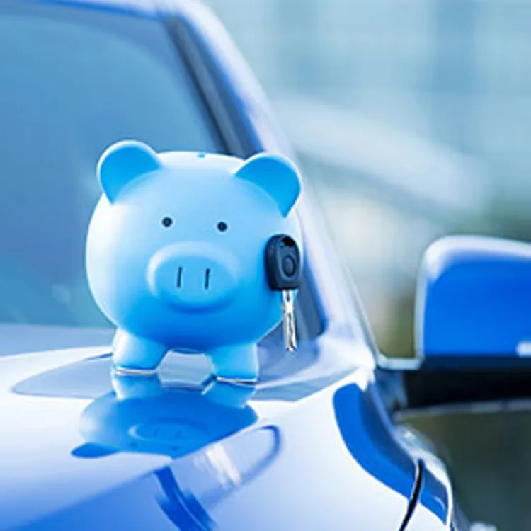 blue piggy bank on top of blue car's hood
