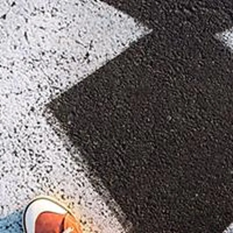 Person standing on two arrows pointing towards rent or buy