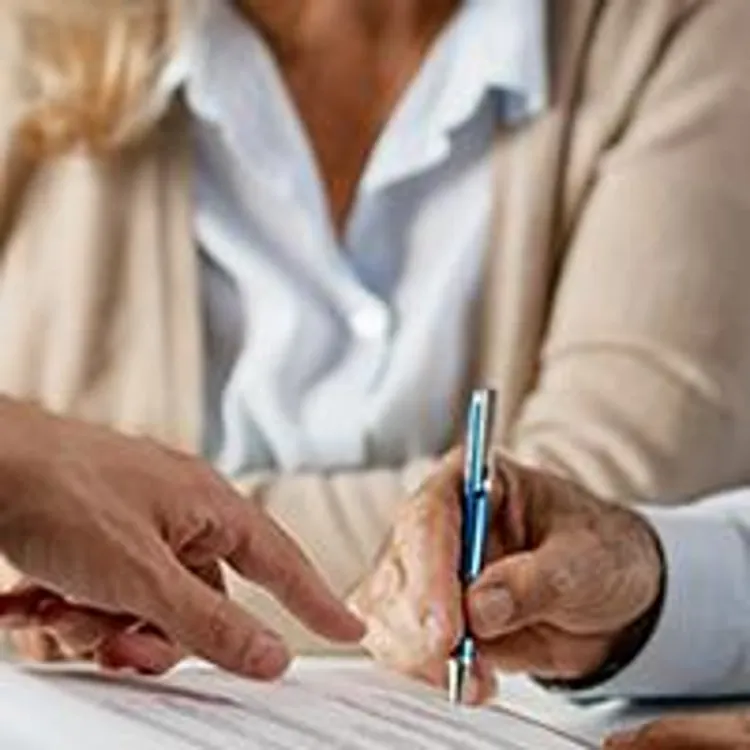 older couple signing mortgage paperwork