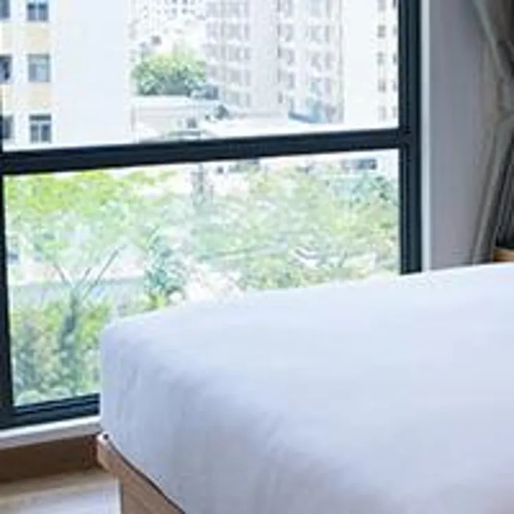 white bed next to panoramic window