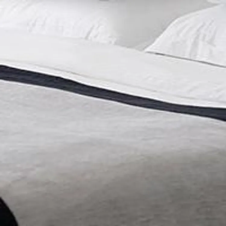 bed with white and gray bedsheets