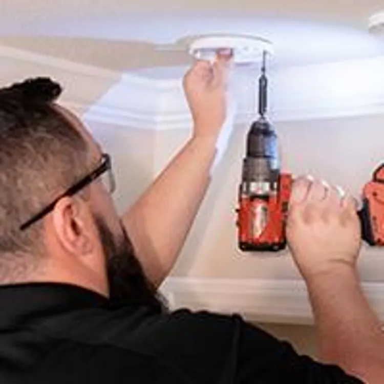 home security employee installing a security system