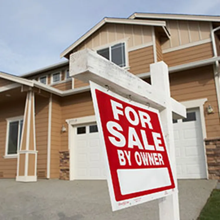 for sale sign in front of a house