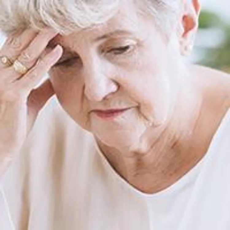 senior woman with her head in her hand