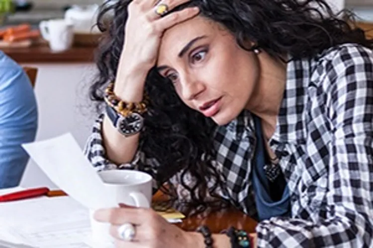 stressed woman holding papers