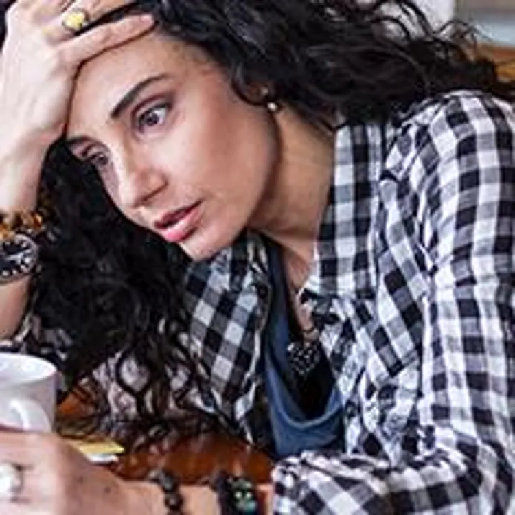 stressed woman holding papers