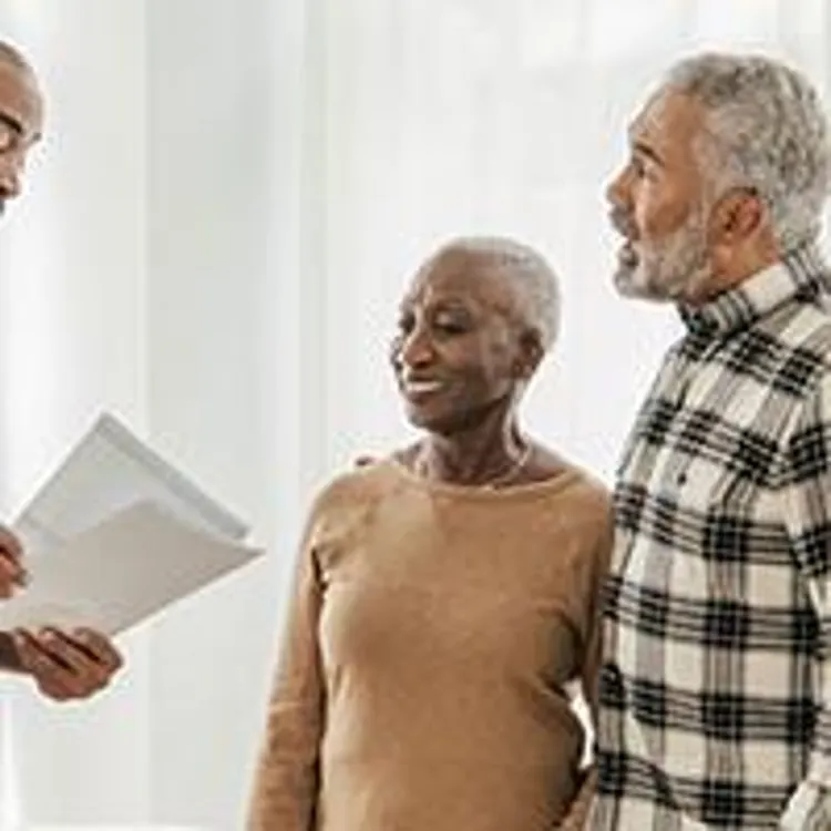elderly couple discussing with a mortgage broker
