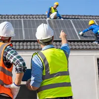 engineers installing solar panels on roof of a home