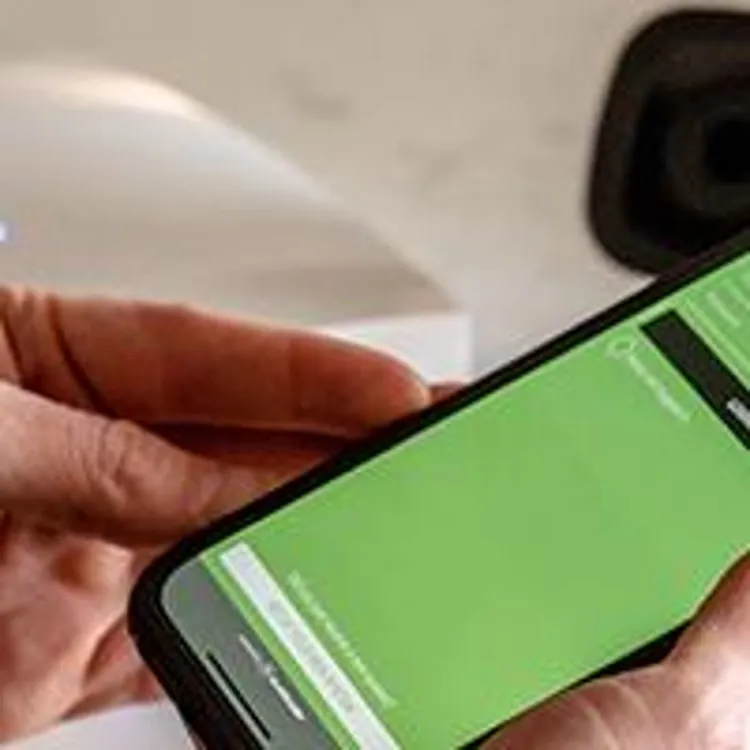 man setting up frontpoint security system via phone app