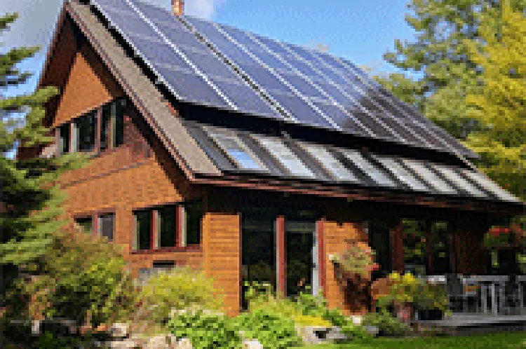 nice house made of glass and bricks with solar roof on a bright day