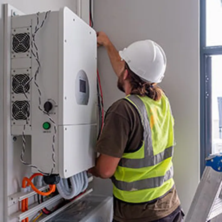 an electrician connecting a solar inverter