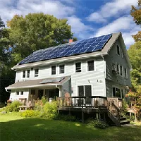 Big house with solar panels on a hill in on a bright sunny day