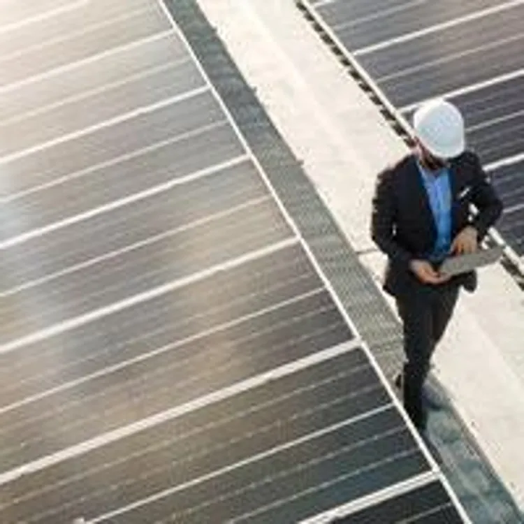 engineer inspecting solar panels on a roof