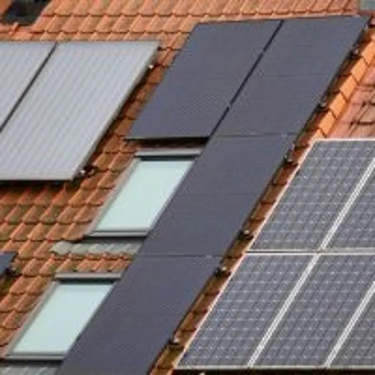 solar panels installed on a red tile roof with skylights