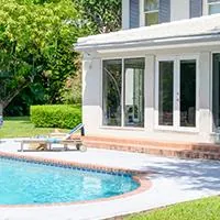 house with in-ground swimming pool in the backyard