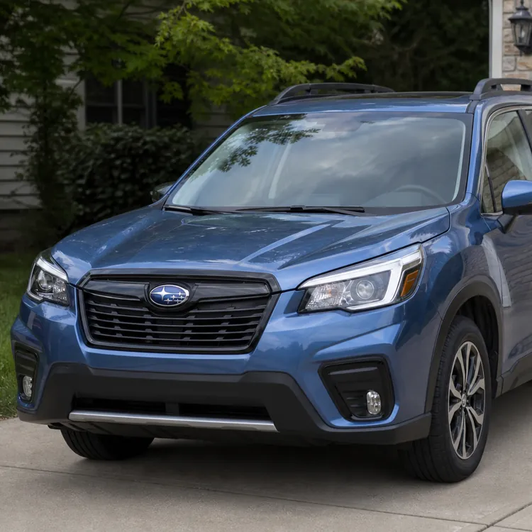 Blue SUV parked on a driveway in front of a white garage door