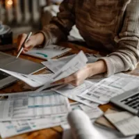 a person filing taxes on a messy table