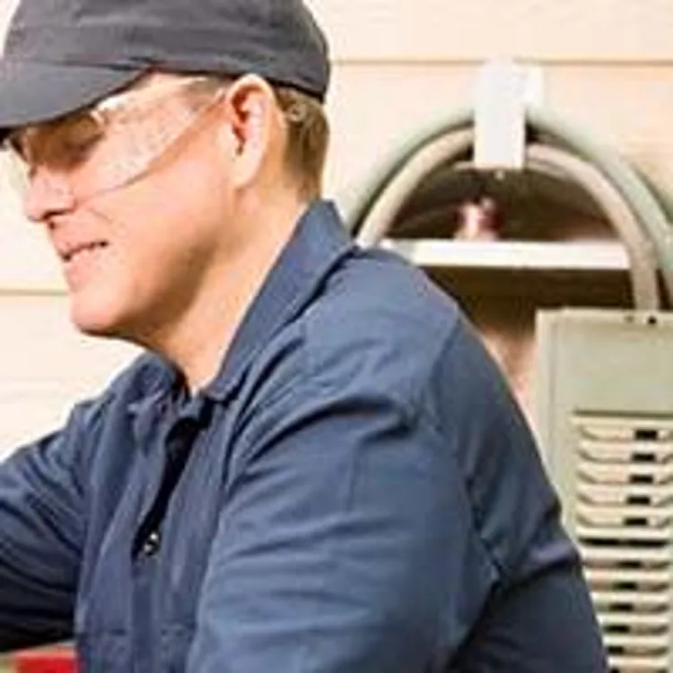 tech working on air conditioner