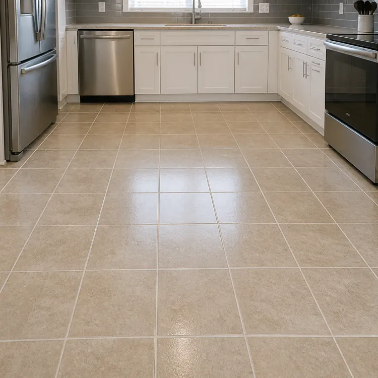 Modern kitchen with stainless steel appliances, white cabinets, and beige tile flooring