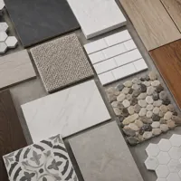 Assorted flooring samples including wood, tile, carpet, and stone arranged on a flat surface