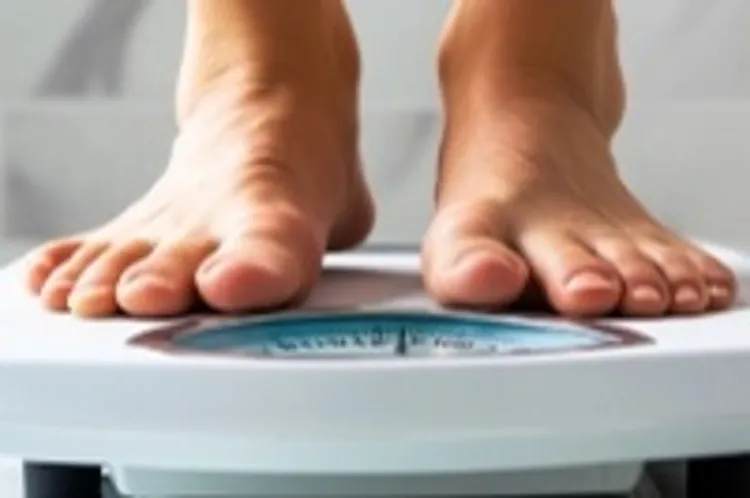 someone stepping on a weighing scale