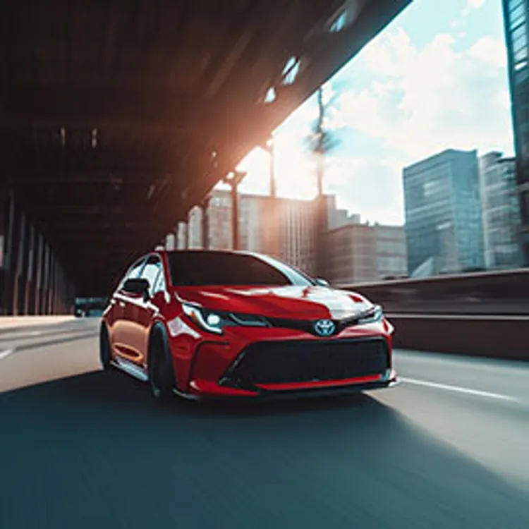 red toyota sedan on a city road