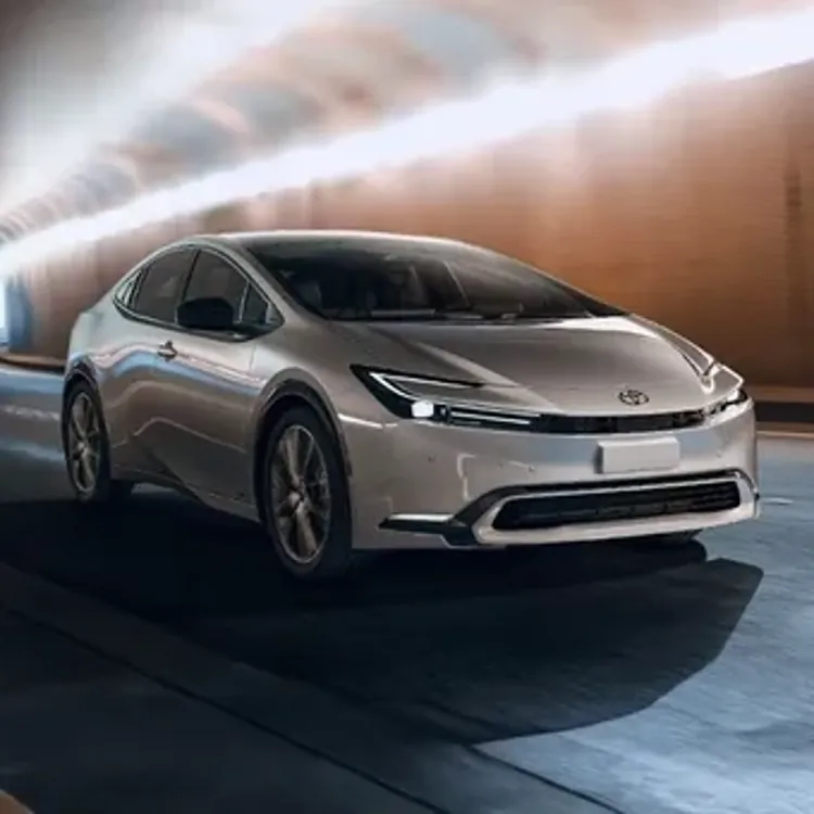 silver toyota prius driving through a well-lit tunnel