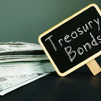 a stack of dollar notes besides a treasury bonds sign