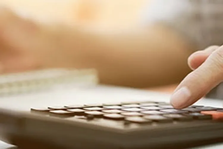 senior lady hand using calculator computing expenses
