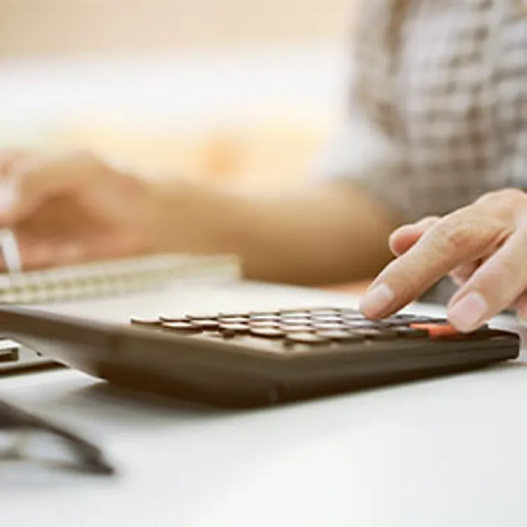 senior lady hand using calculator computing expenses
