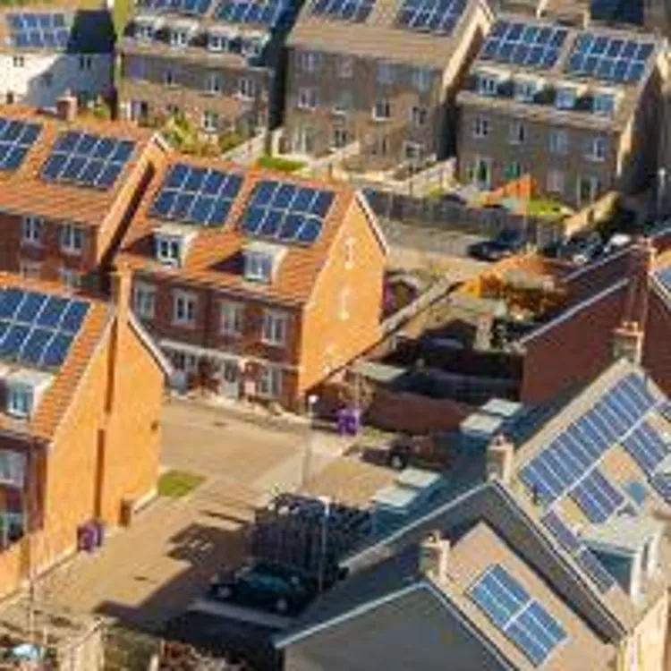 aerial view of a housing development with solar panels on top of roofs