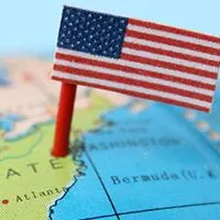 blue globe with a united states flag pinned on the united states