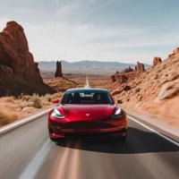 a red Tesla on a highway