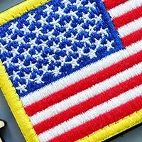 american flag with wooden homes