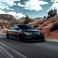 black volkswagen jetta on a mountain road